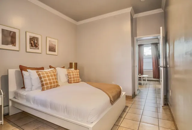 a bedroom with a bed and a walk in closet