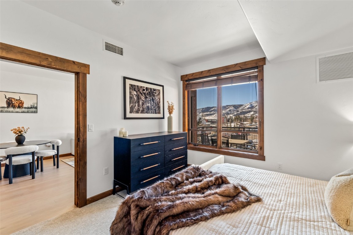 1175 Bangtail Way, Unit 2106 Steamboat Springs, CO 80487 - Photo 13 of 32 a bedroom with a bed and a window