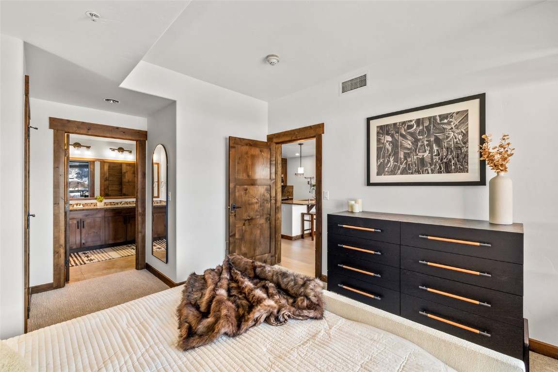 1175 Bangtail Way, Unit 2106 Steamboat Springs, CO 80487 - Photo 14 of 32 a bedroom with a bed and a dresser