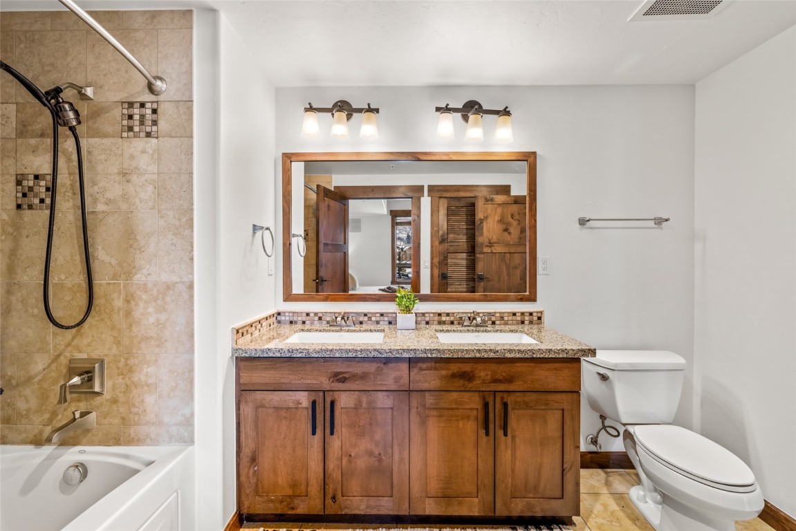 1175 Bangtail Way, Unit 2106 Steamboat Springs, CO 80487 - Photo 15 of 32 a bathroom with a sink mirror vanity and toilet