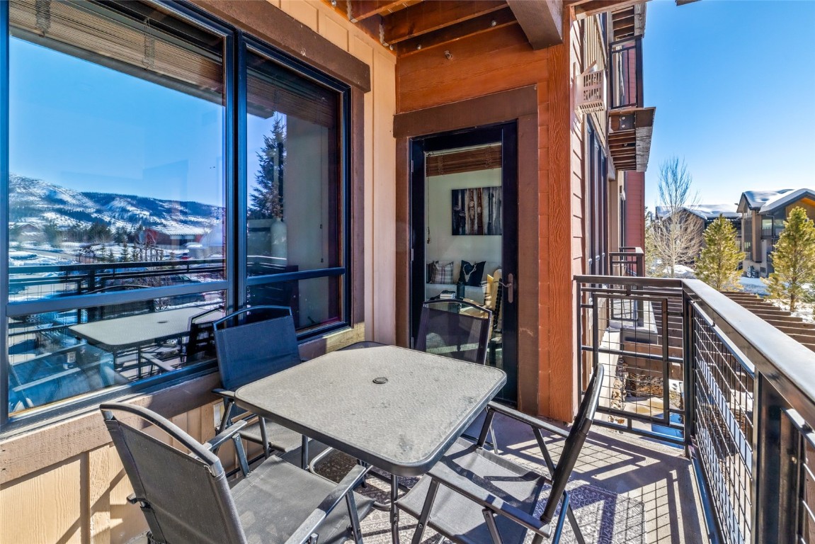 1175 Bangtail Way, Unit 2106 Steamboat Springs, CO 80487 - Photo 20 of 32 a backyard of a house with barbeque oven table and chairs