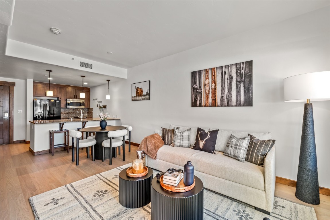 1175 Bangtail Way, Unit 2106 Steamboat Springs, CO 80487 - Photo 6 of 32 a living room with furniture and wooden floor