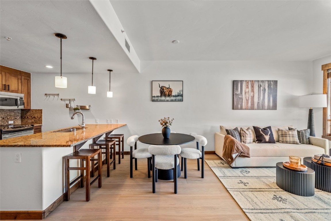 1175 Bangtail Way, Unit 2106 Steamboat Springs, CO 80487 - Photo 7 of 32 a living room with furniture and a wooden floor