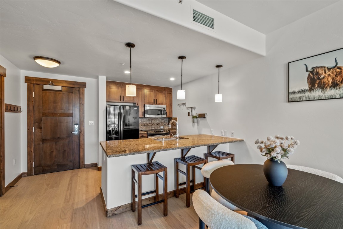 1175 Bangtail Way, Unit 2106 Steamboat Springs, CO 80487 - Photo 8 of 32 a dining room with a table and chairs