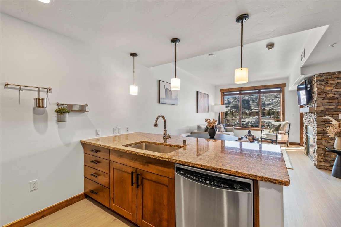 1175 Bangtail Way, Unit 2106 Steamboat Springs, CO 80487 - Photo 10 of 32 a kitchen with a sink a counter space and wooden floor