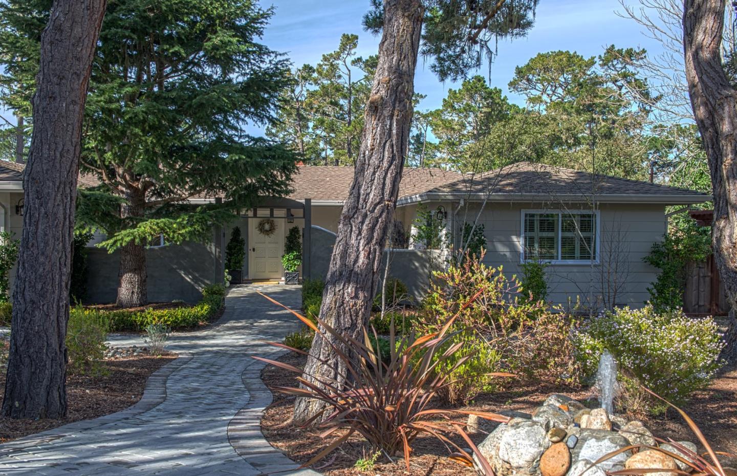 3048 Larkin Road Pebble Beach, CA 93953 - Photo 1 of 24 a front view of a house with garden