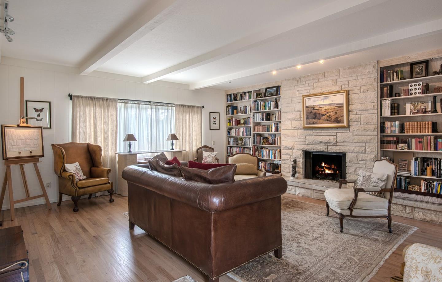 3048 Larkin Road Pebble Beach, CA 93953 - Photo 11 of 24 a living room with furniture a rug a fireplace and a window