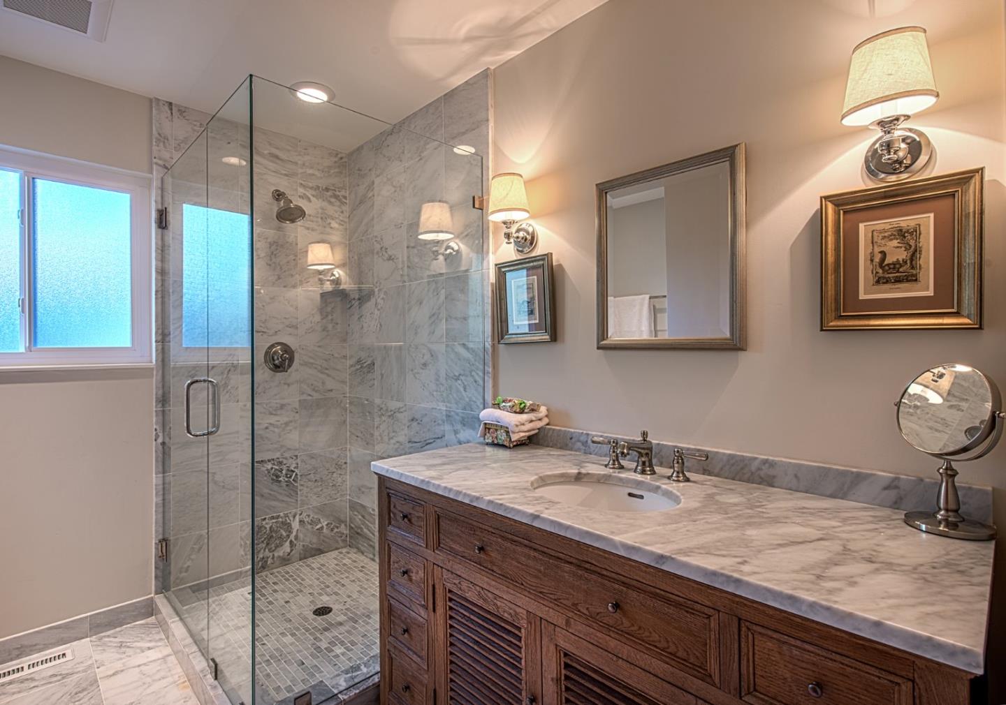 3048 Larkin Road Pebble Beach, CA 93953 - Photo 19 of 24 a bathroom with a sink a light fixture and a mirror