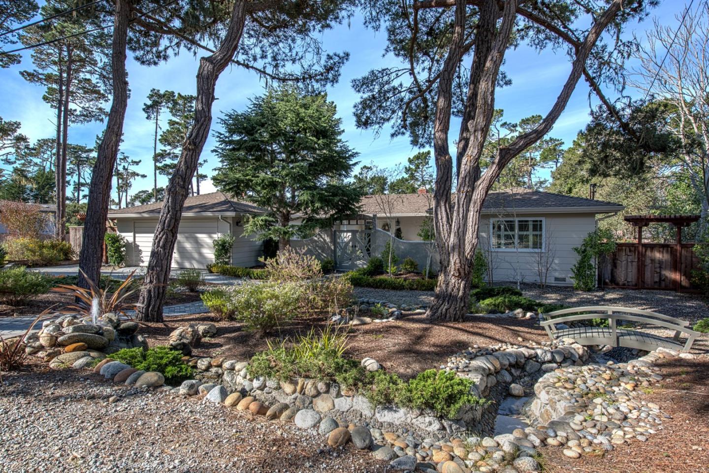 3048 Larkin Road Pebble Beach, CA 93953 - Photo 2 of 24 a backyard of a house with barbeque oven and outdoor seating