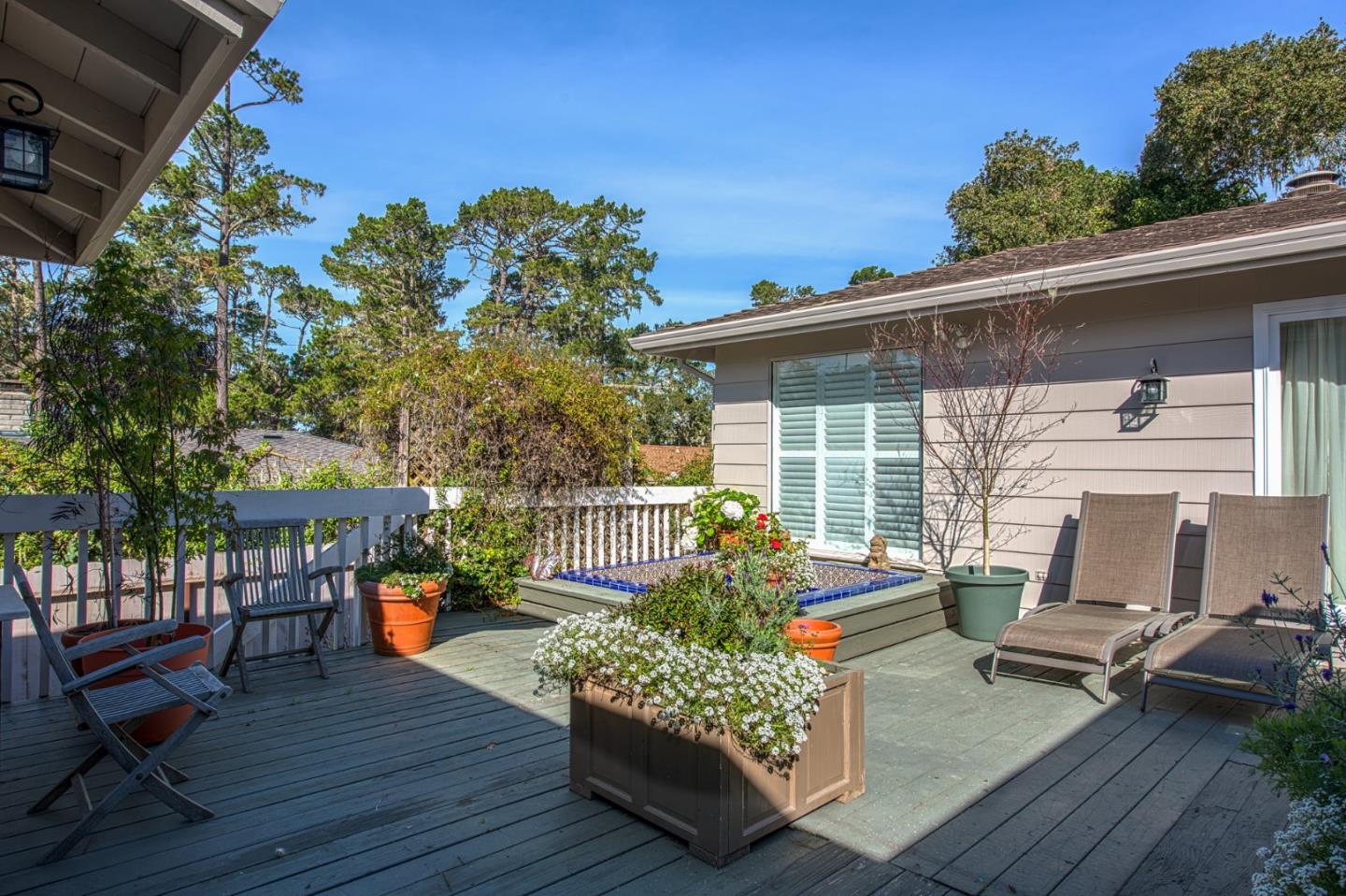 3048 Larkin Road Pebble Beach, CA 93953 - Photo 22 of 24 a roof deck with table and chairs and potted plants