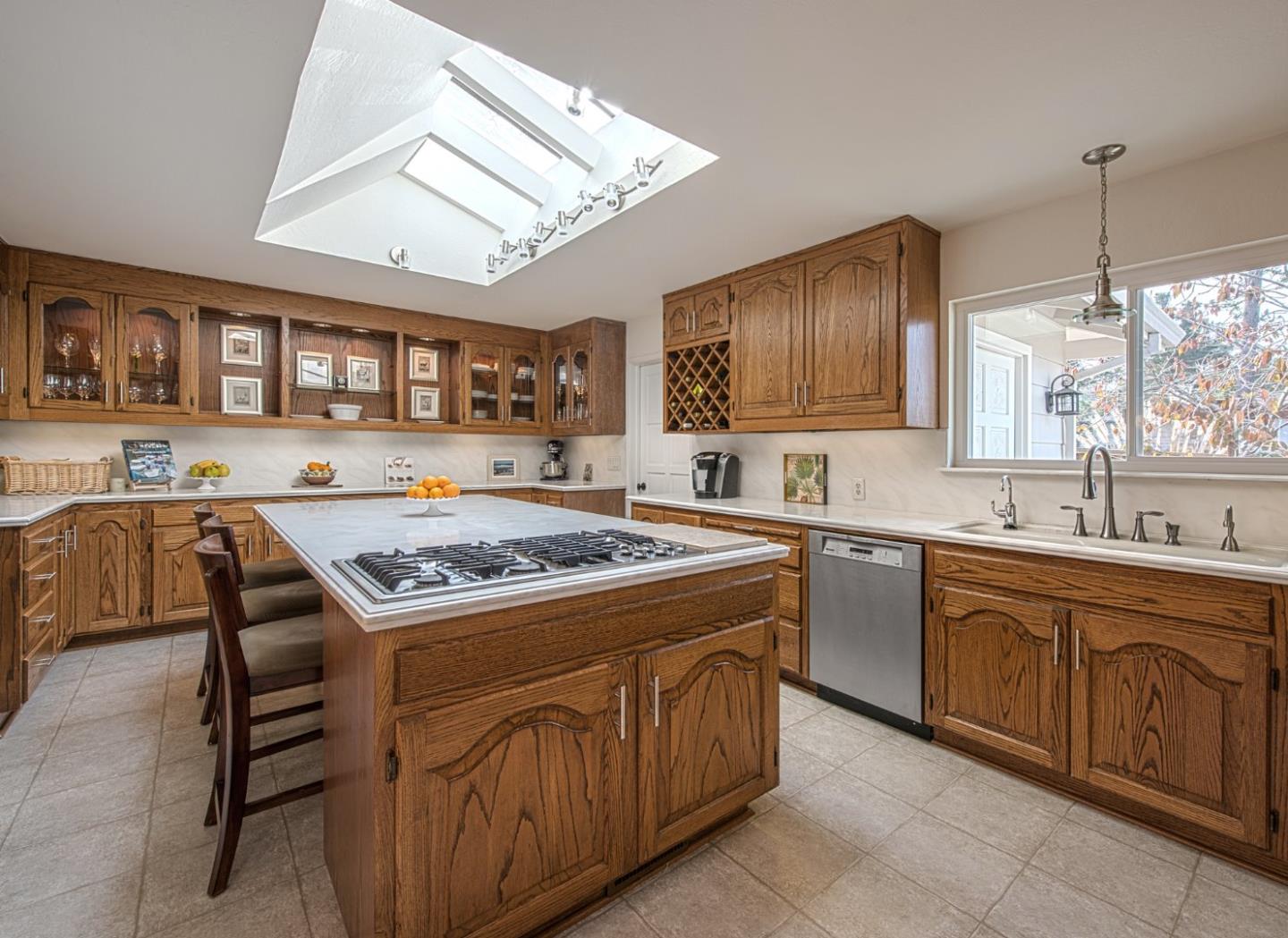 3048 Larkin Road Pebble Beach, CA 93953 - Photo 6 of 24 a kitchen that has a sink and a stove in it