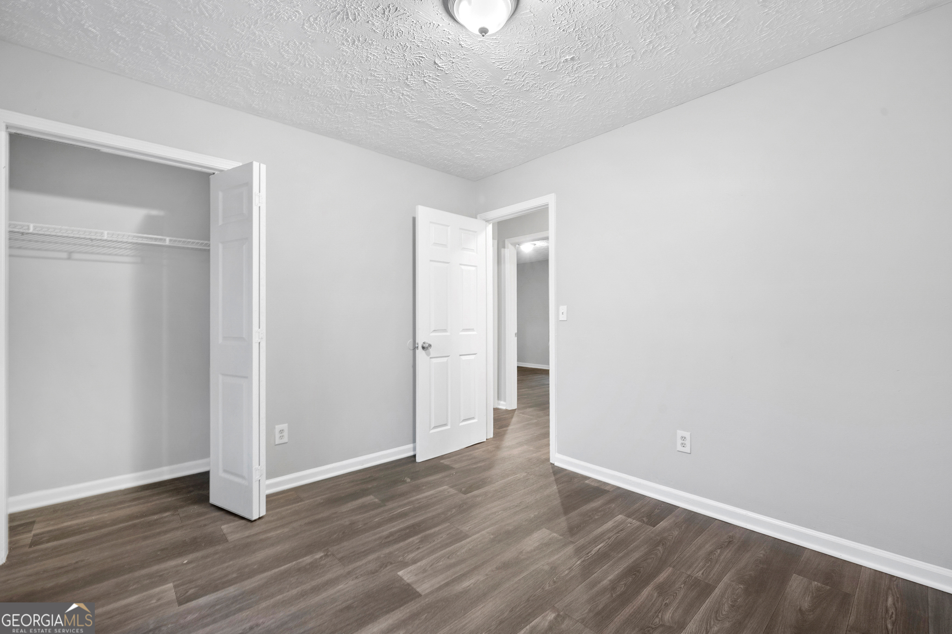 6155 Pointer Way Douglasville, GA 30135 - Photo 11 of 26 a view of an empty room with wooden floor