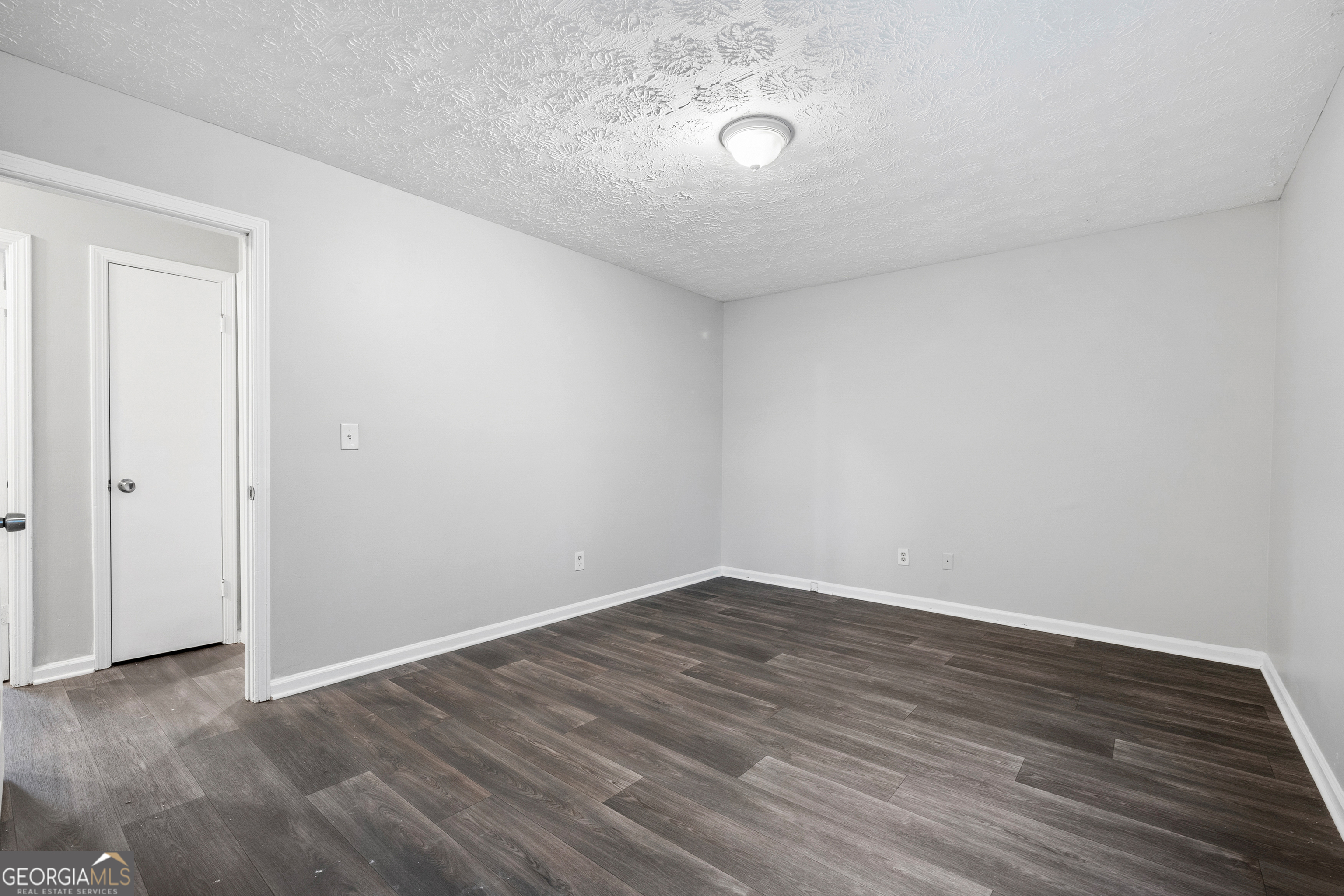 6155 Pointer Way Douglasville, GA 30135 - Photo 14 of 26 a view of an empty room with wooden floor and a window
