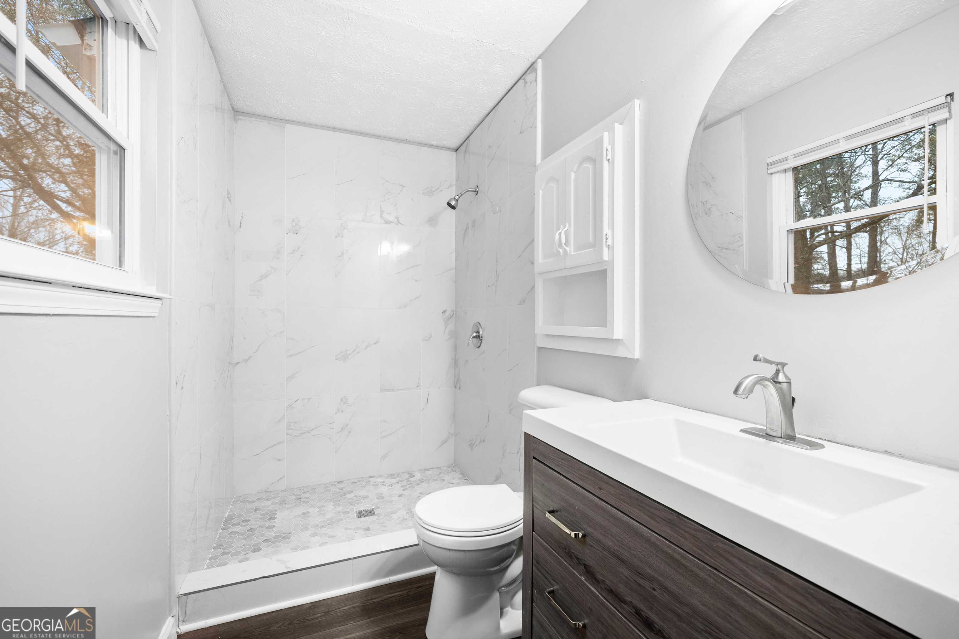 6155 Pointer Way Douglasville, GA 30135 - Photo 16 of 26 a bathroom with a sink a toilet and shower