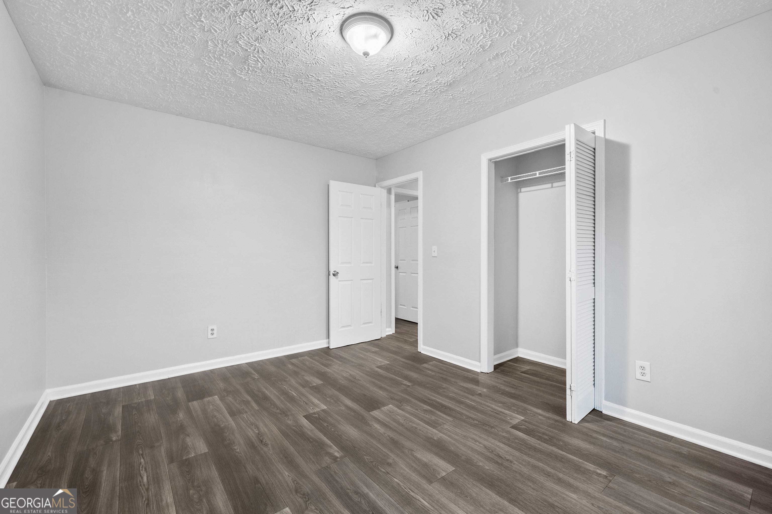 6155 Pointer Way Douglasville, GA 30135 - Photo 18 of 26 a view of an empty room with wooden floor