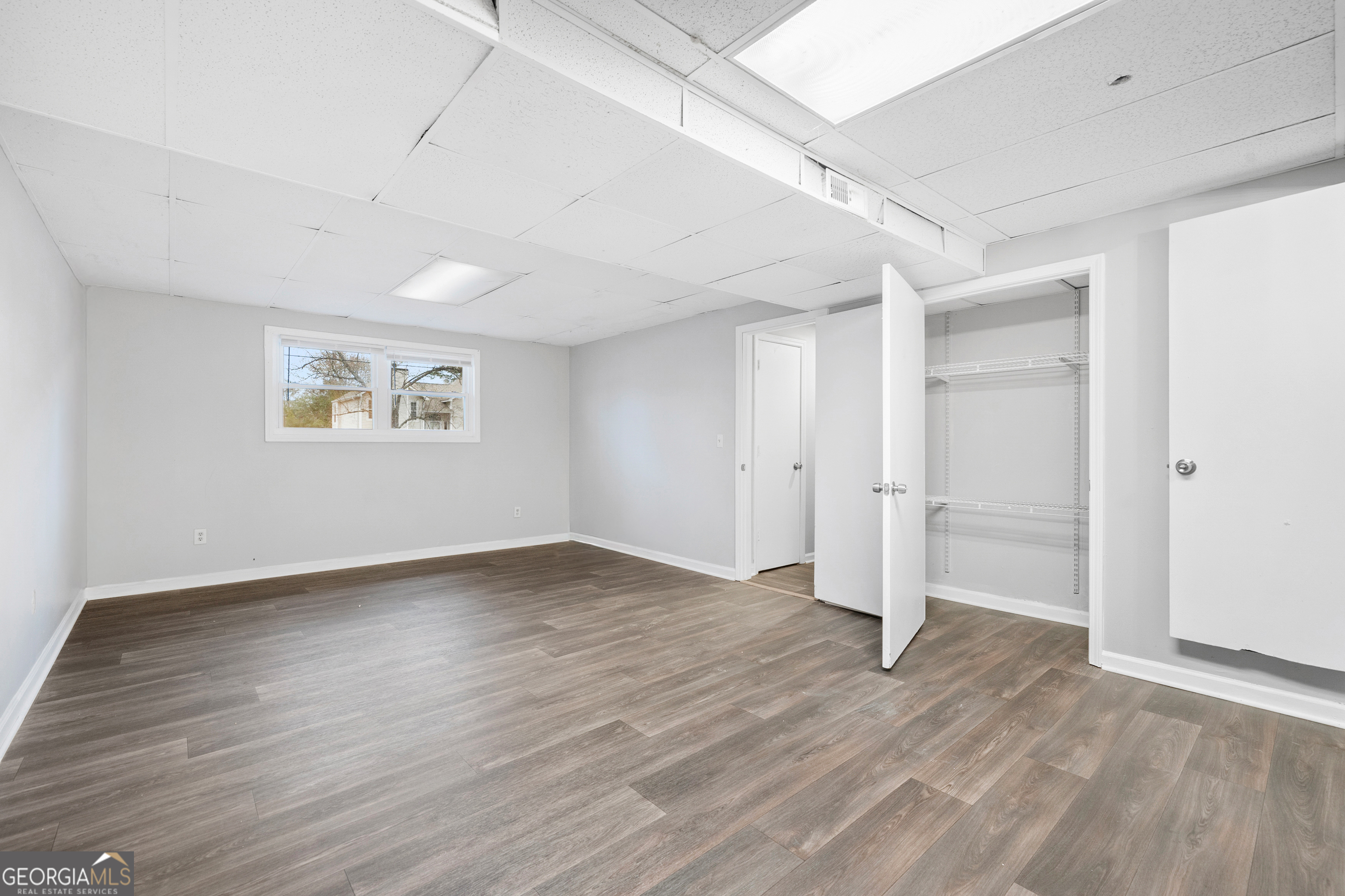 6155 Pointer Way Douglasville, GA 30135 - Photo 19 of 26 an empty room with wooden floor and window