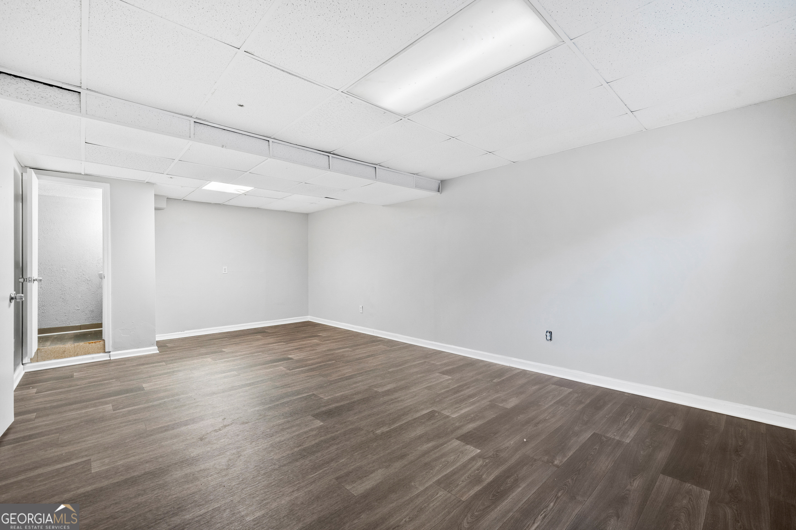 6155 Pointer Way Douglasville, GA 30135 - Photo 20 of 26 a view of an empty room with wooden floor