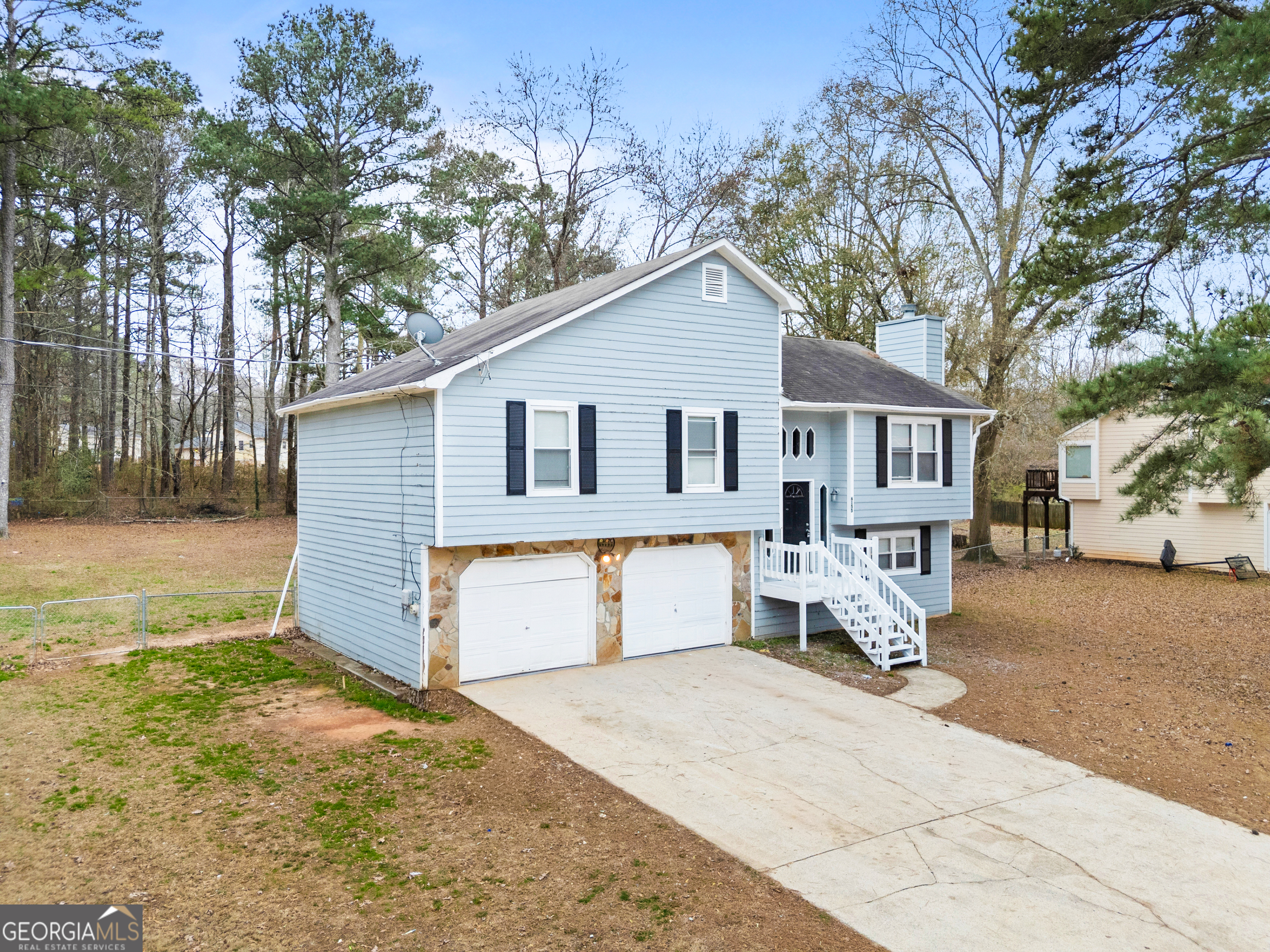 6155 Pointer Way Douglasville, GA 30135 - Photo 2 of 26 a front view of a house with a yard and garage
