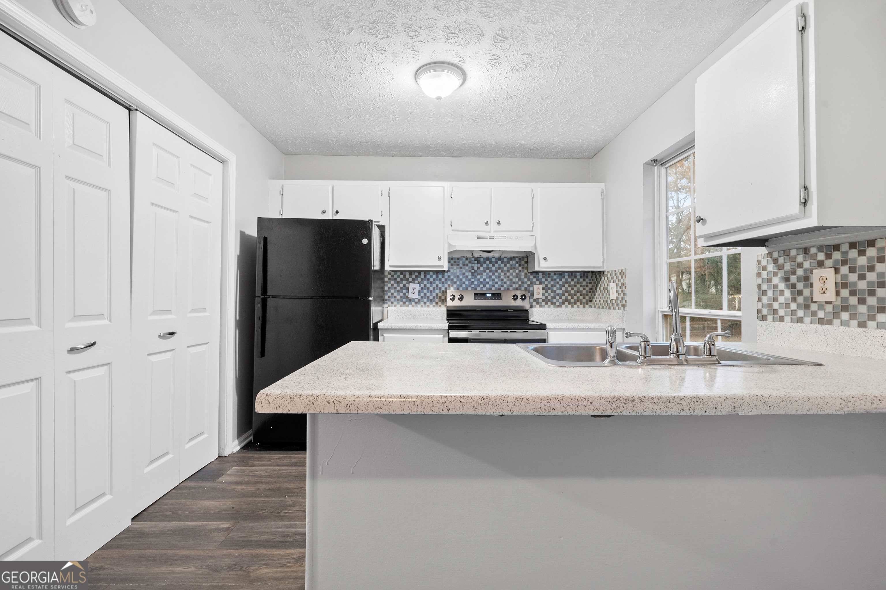 6155 Pointer Way Douglasville, GA 30135 - Photo 4 of 26 a kitchen with stainless steel appliances a refrigerator and a stove