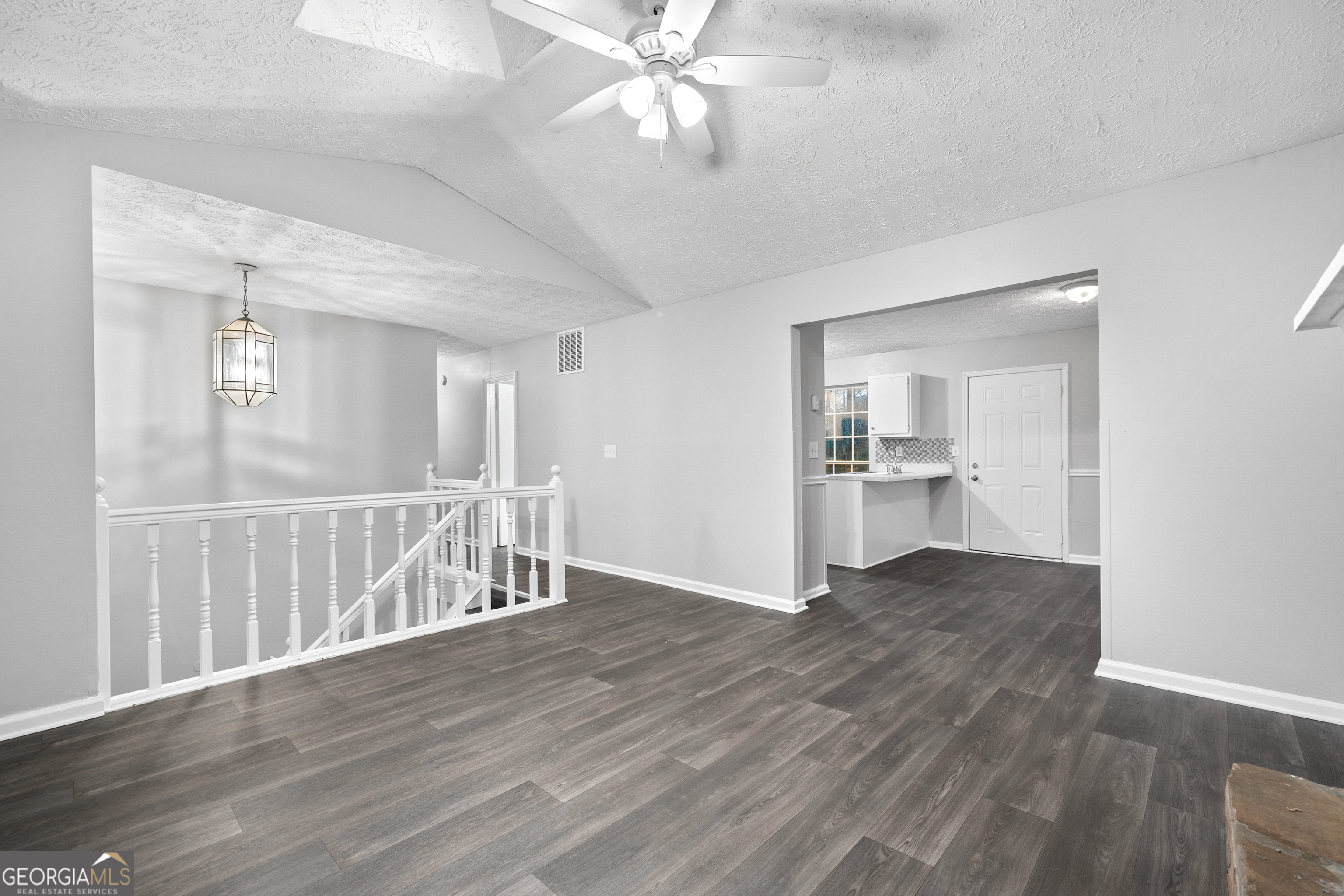 6155 Pointer Way Douglasville, GA 30135 - Photo 7 of 26 a view of wooden floor and a chandelier fan in a room