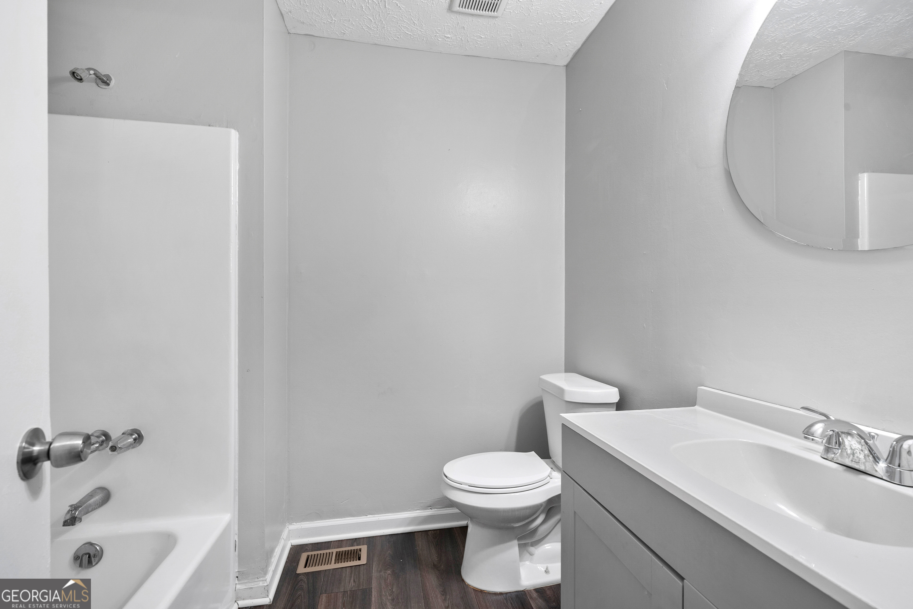 6155 Pointer Way Douglasville, GA 30135 - Photo 9 of 26 a white toilet sitting next to a bathroom sink and tub