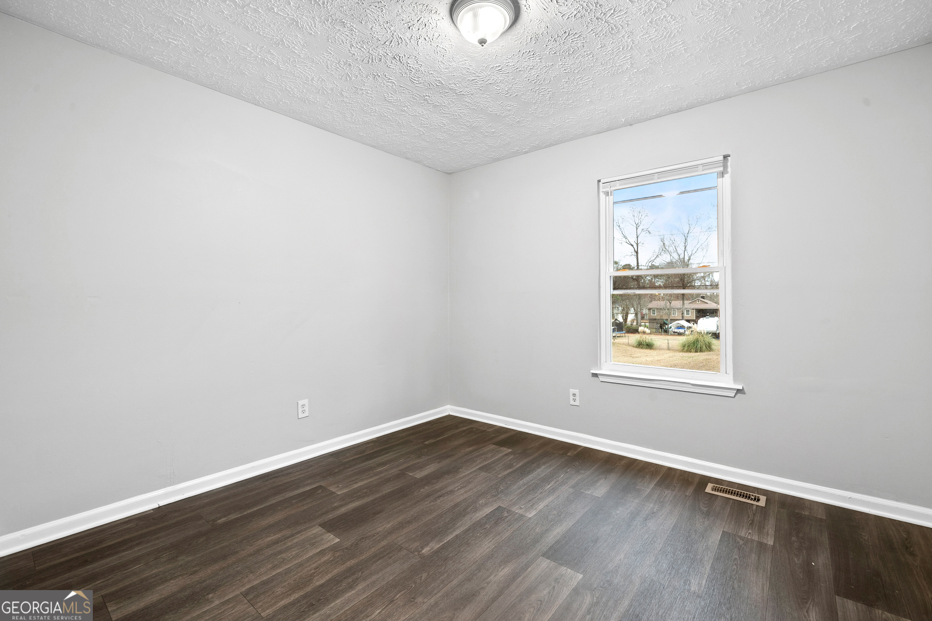 6155 Pointer Way Douglasville, GA 30135 - Photo 10 of 26 an empty room with wooden floor and windows
