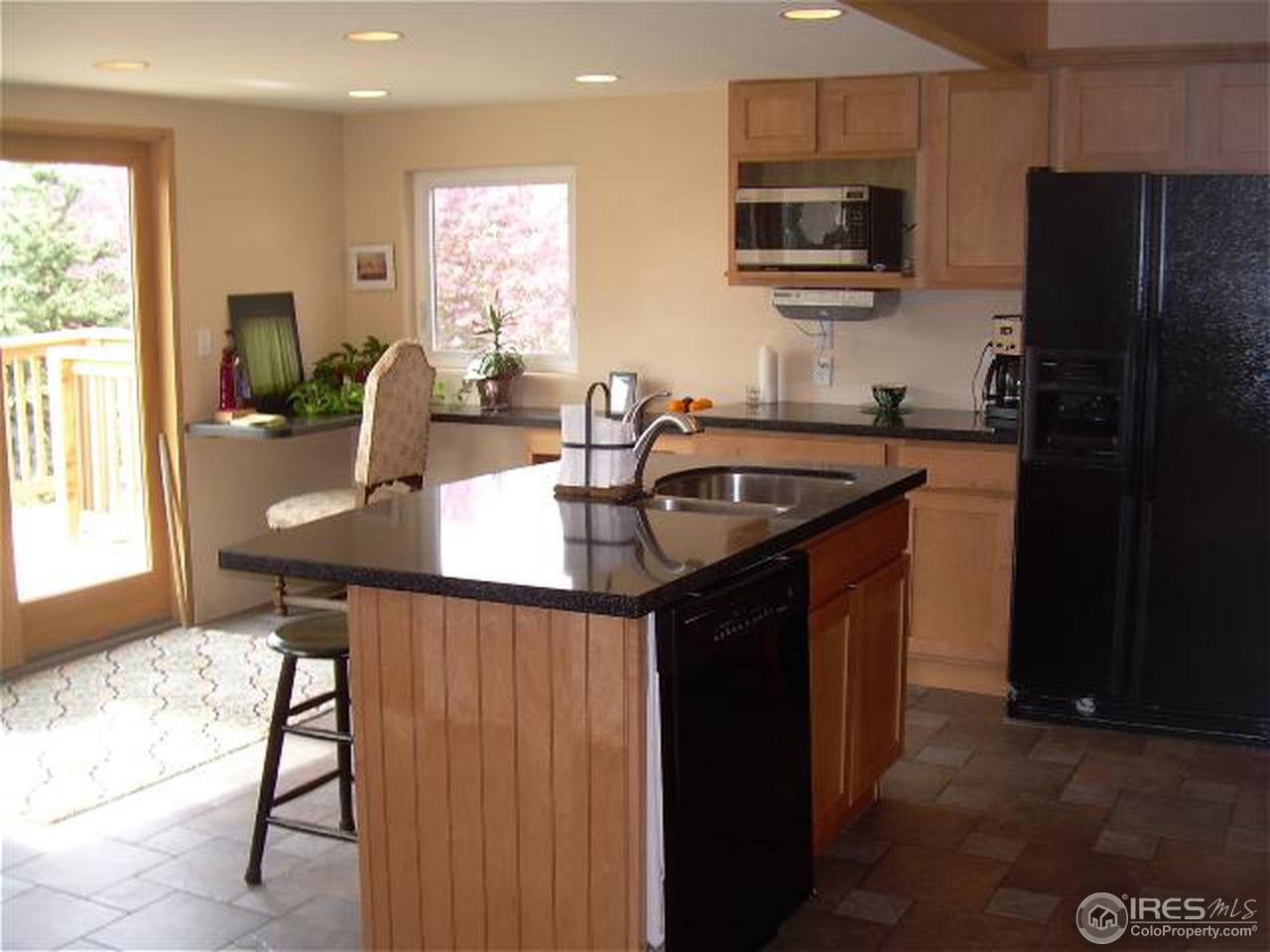 7701 O Connor Road Boulder, CO 80303 - Photo 6 of 18 a kitchen with stainless steel appliances granite countertop a sink refrigerator stove and microwave