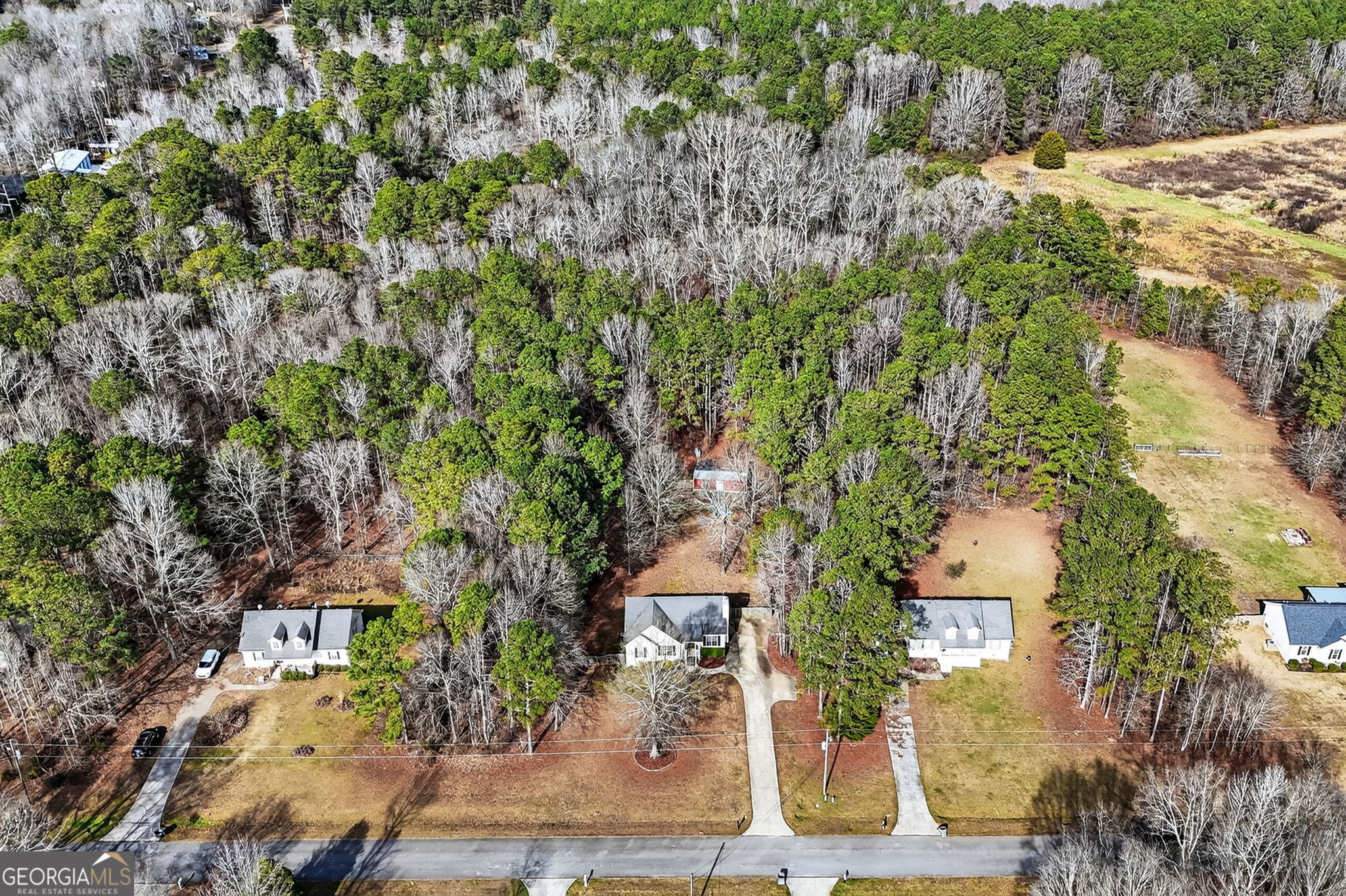 an aerial view of a house with yard