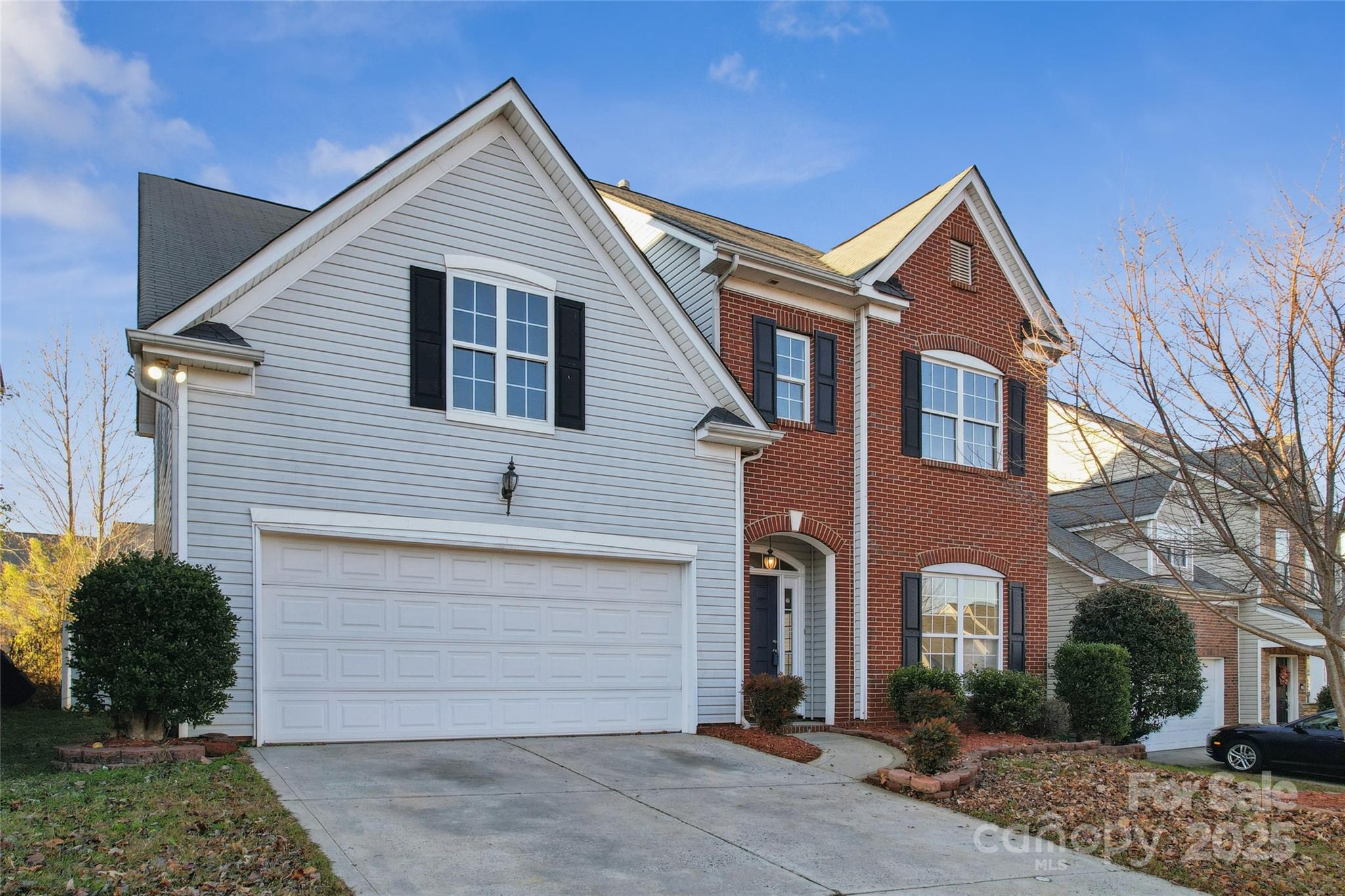 a view of a house with a yard and garage