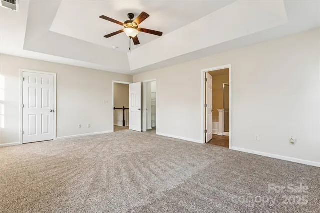 a view of an empty room with a ceiling fan