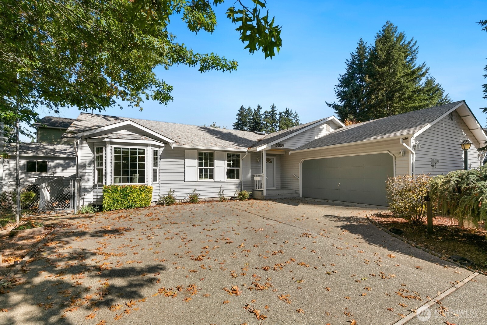 3908 Northeast 10th Street Renton, WA 98056 - Photo 1 of 29 a front view of a house with a yard and potted plants