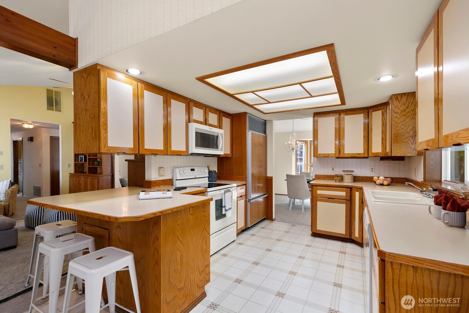 3908 Northeast 10th Street Renton, WA 98056 - Photo 11 of 29 a kitchen with stainless steel appliances granite countertop a sink stove and refrigerator