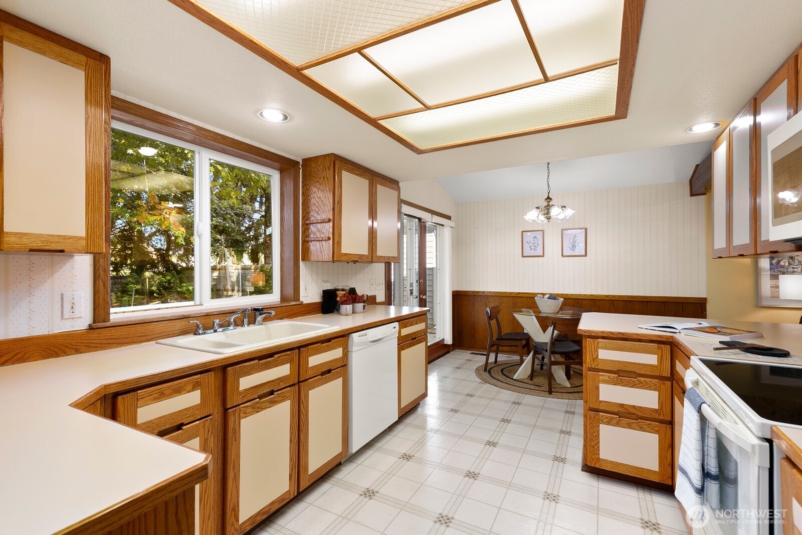 3908 Northeast 10th Street Renton, WA 98056 - Photo 12 of 29 a kitchen with stainless steel appliances granite countertop a sink and a stove