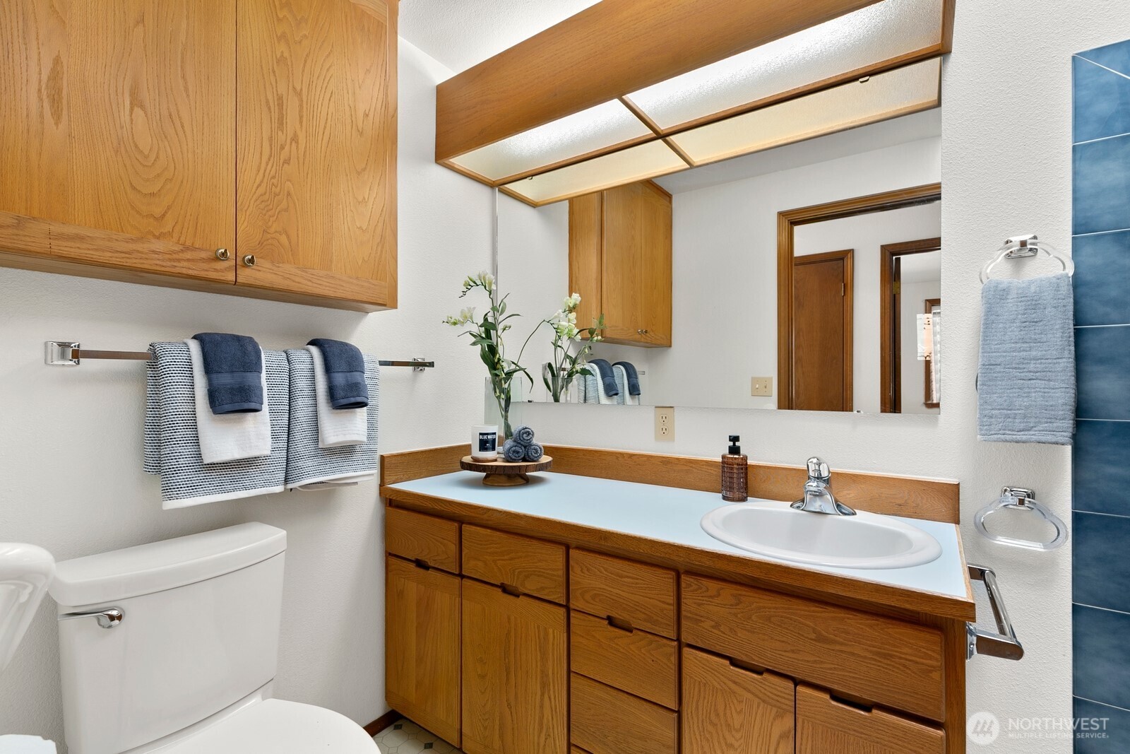 3908 Northeast 10th Street Renton, WA 98056 - Photo 19 of 29 a bathroom with a sink a toilet and mirror