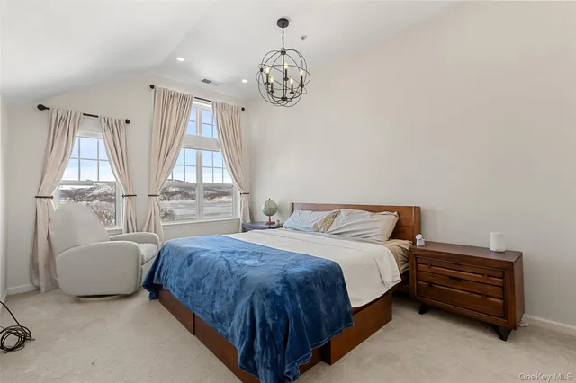 a spacious bedroom with a bed and a window