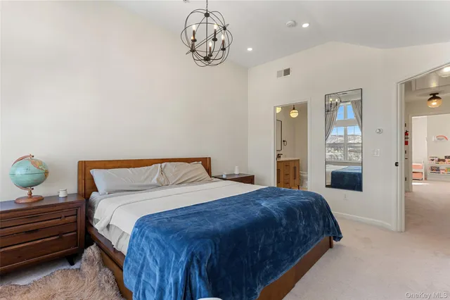 a spacious bedroom with a bed and cabinets