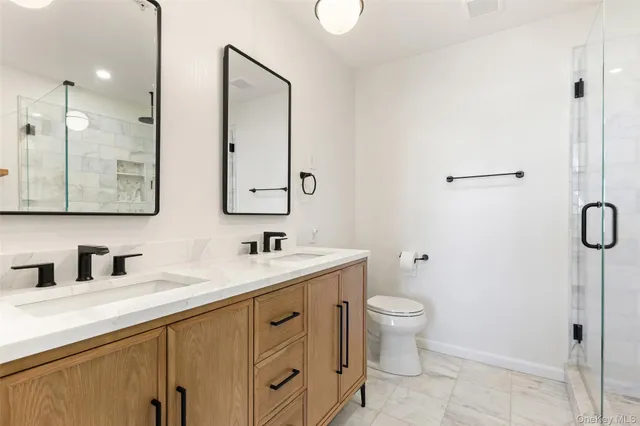 a bathroom with a toilet sink and mirror