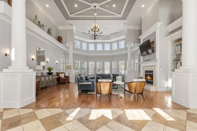 a living room with fireplace furniture and a chandelier