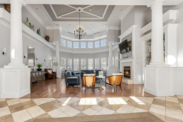 a living room with lots of furniture and chandelier