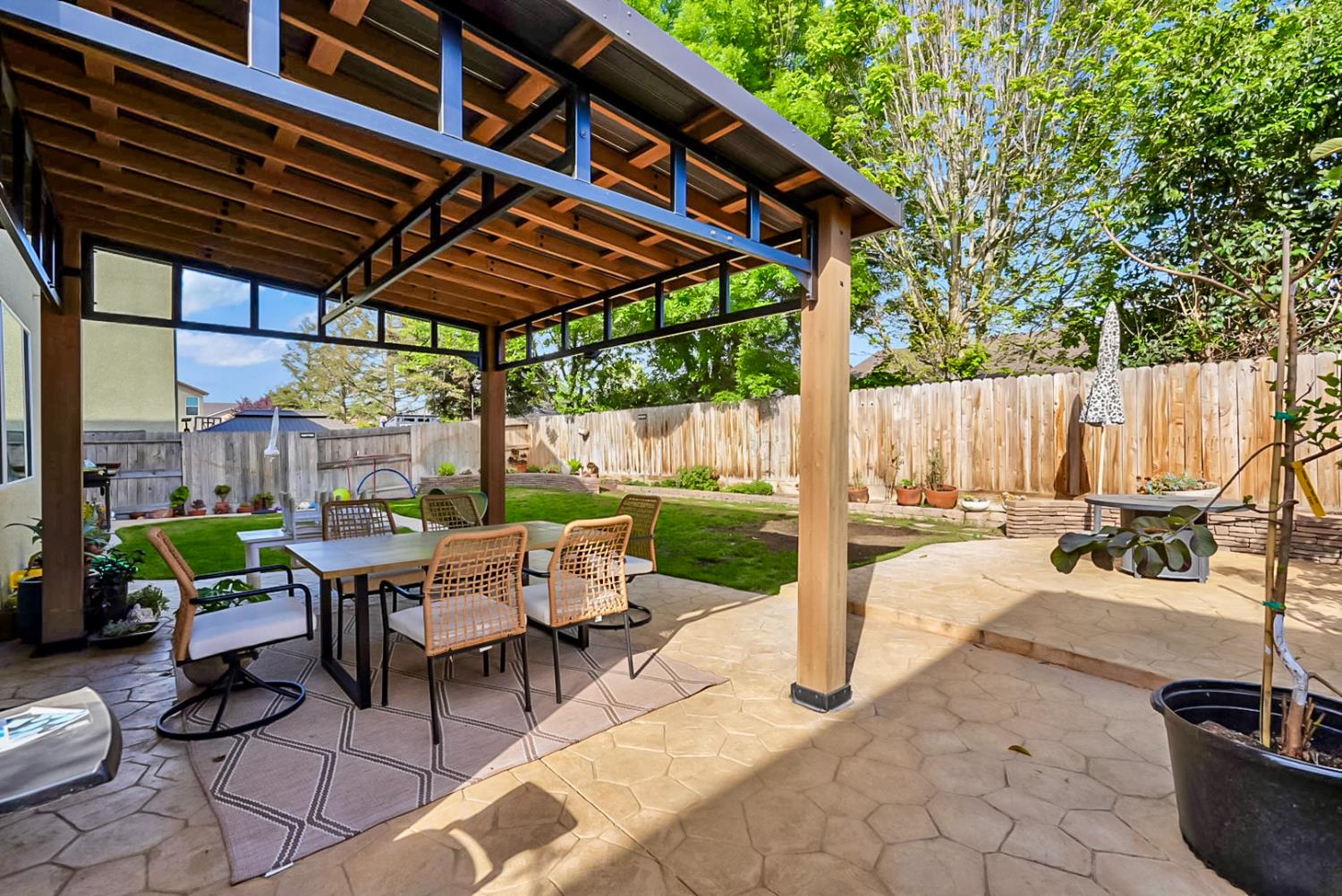 5518 Julia Avenue Keyes, CA 95328 - Photo 19 of 22 a view of patio with table and chairs potted plants and large tree