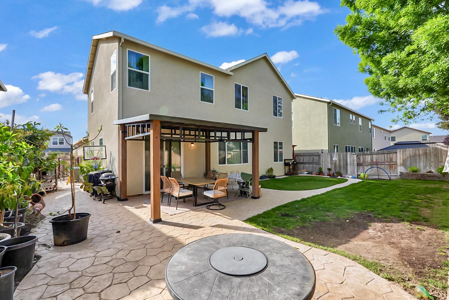 5518 Julia Avenue Keyes, CA 95328 - Photo 20 of 22 a view of a house with backyard sitting area and garden