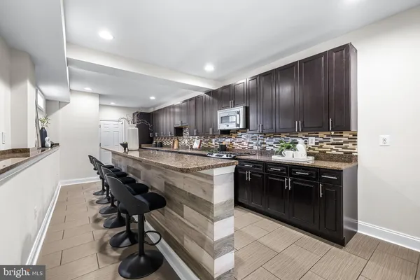 a room with wooden cabinets and stainless steel appliances