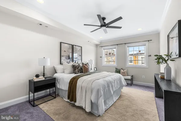 a bedroom with a large bed and a window