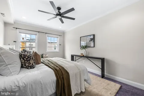 a bedroom with a large bed and a window