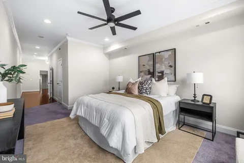 a spacious bedroom with a bed and a lamp