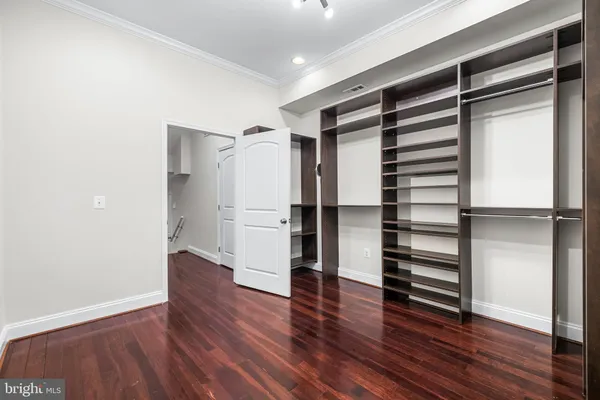 a bathroom with a granite countertop toilet sink and mirror