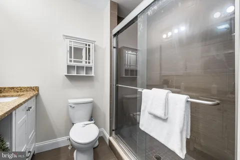 a white toilet sitting next to a bathroom sink