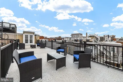 a view of a terrace with couches and pool