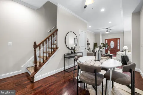 a view of a dining room with furniture and wooden floor