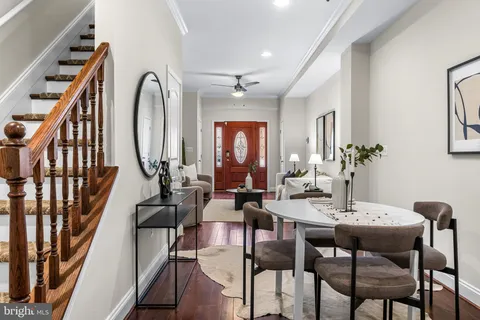a view of a dining room with furniture chandelier and wooden floor